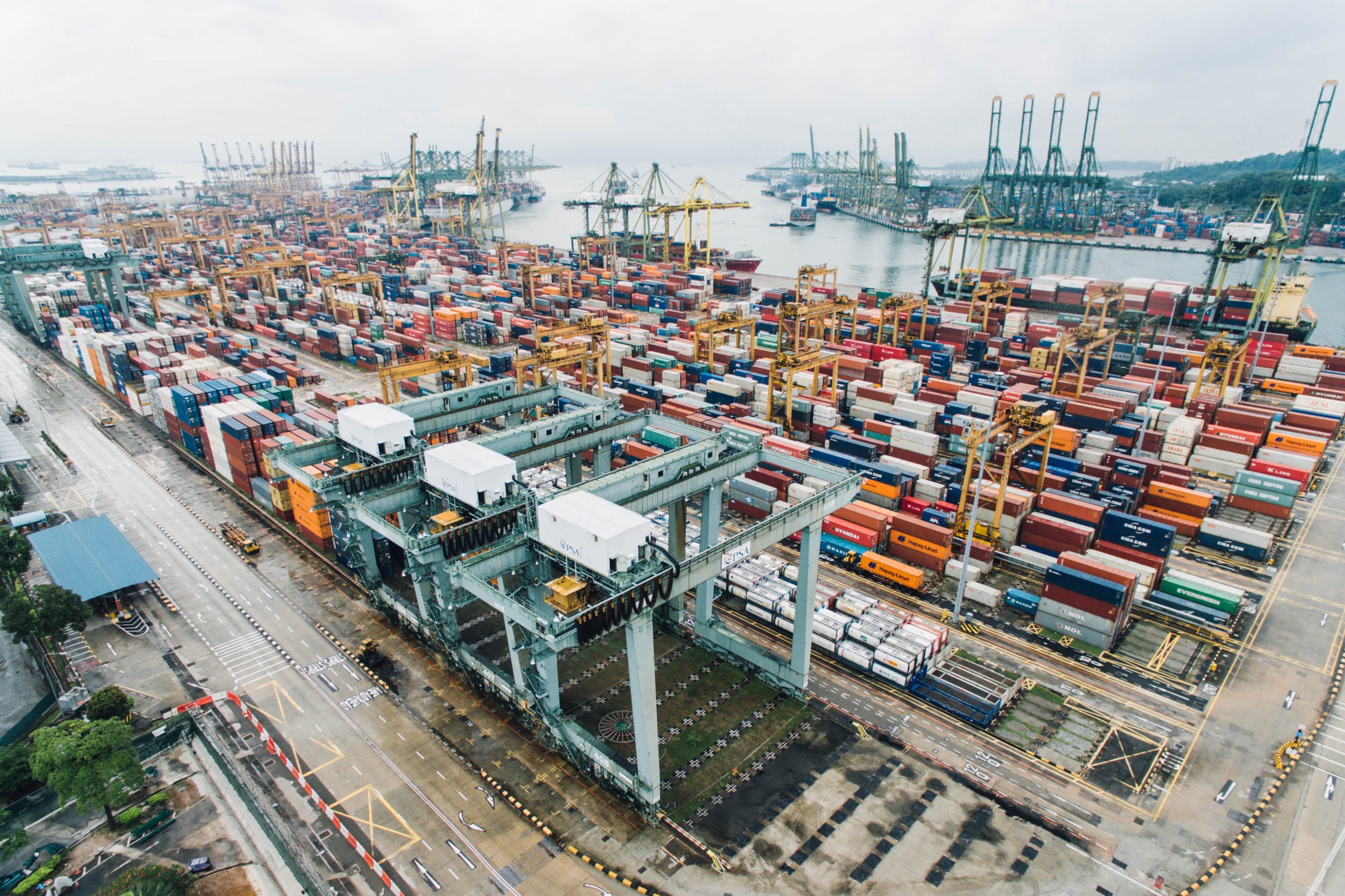 Chokepoints of Power: Maritime Conflict, Global Supply Chains, and Imperialist Rivalry in Southeast Asia 3 Aerial view of cranes and stacked shipping containers at a Singapore container terminal.
